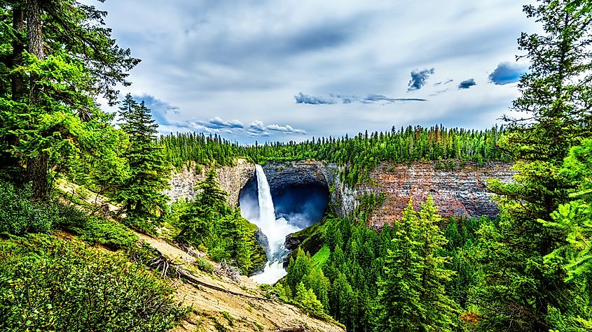 Editorial Photo Credit: Harry Beugelink via Shutterstock. Helmcken Falls, the most famous waterfall in Wells Gray Provincial Park in British Columbia, Canada with the falls at peak volume during spring snow melt