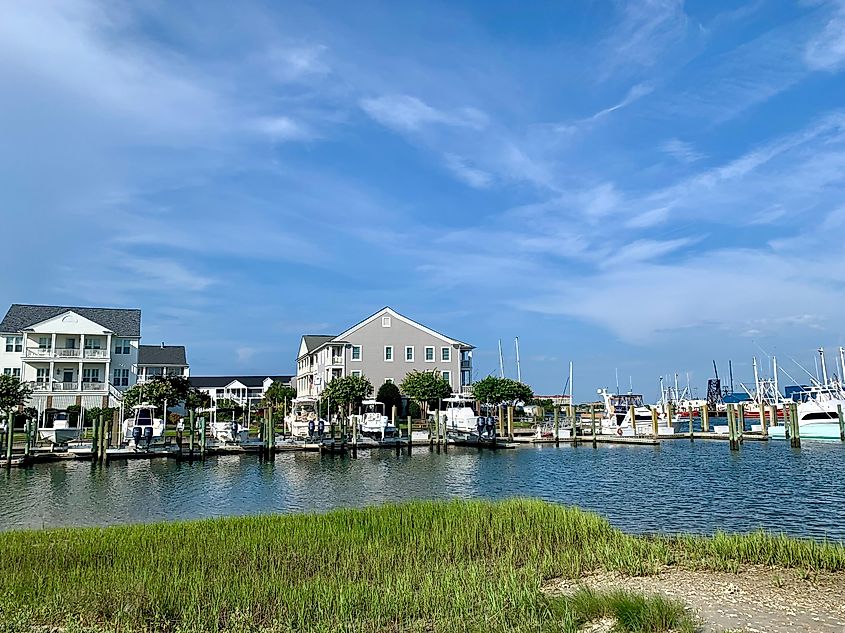 Waterfront homes, recreational and sport fishing boats, and shrimp trawlers in Beaufort Harbor, Beaufort, North Carolina.
