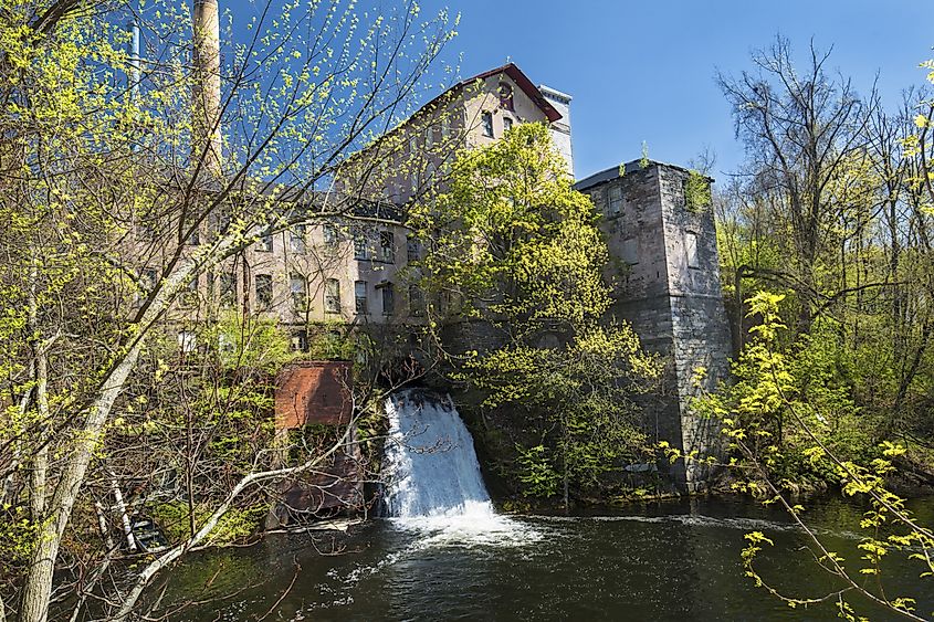 Historic, 19th century mill, known as Dart's Stone Mill, with water power sluice on the Hockanum River in Rockville, Connecticut.