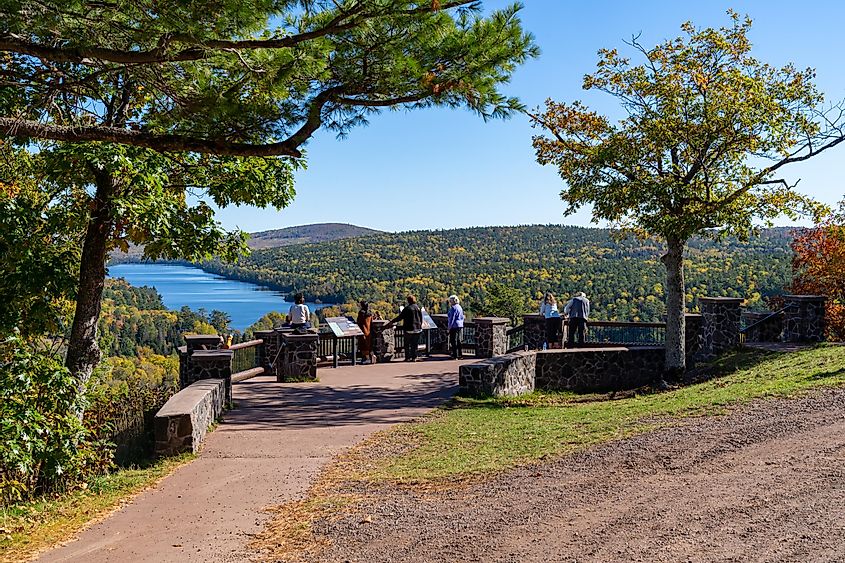 Tourists enjoy the view from Brockway Mountain Lookout in Michigan during fall, via melissamn / Shutterstock.com