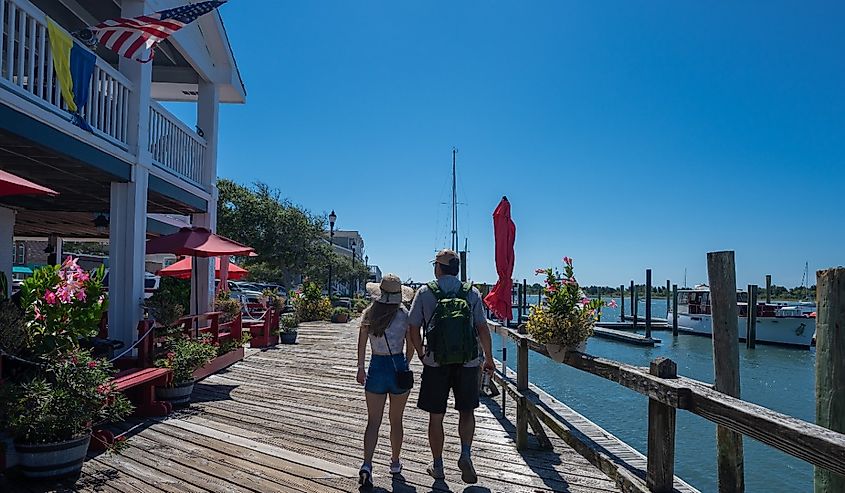 A couple strolls down the boardwalk in Beaufort, South Carolina, on a summers day