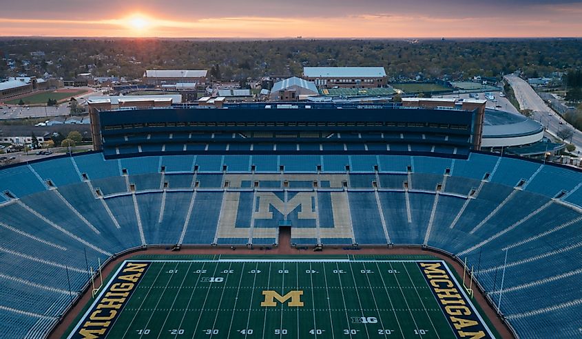 The sun rises behind Michigan Stadium