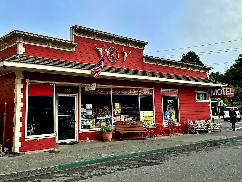 Ferndale, California, USA - Sep 15, 2024: The historic Red Front Store building painted bright red with an American flag, vintage signage, and western-themed decorations in downtown Ferndale.