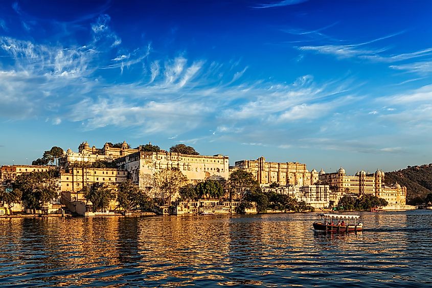 The City Palace and a tourist boat on Lake Pichola in Udaipur