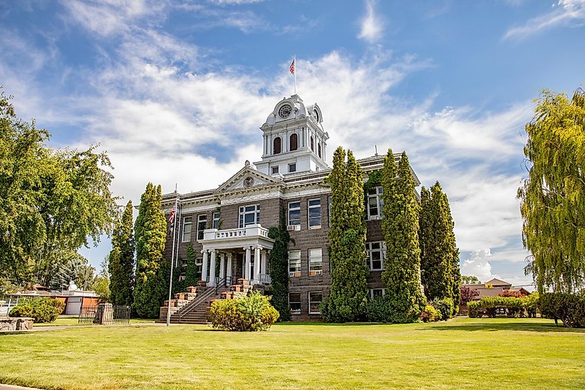 Prineville, Oregon: Crook County Courthouse surrounded by greenery on a sunny summer day.