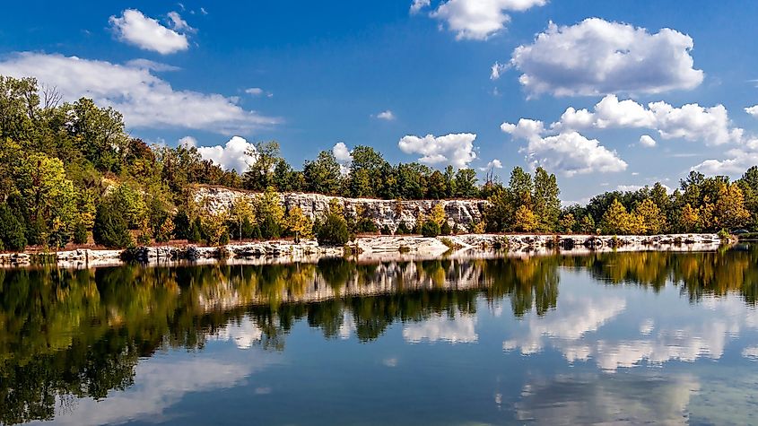 Landscape with lake reflecting cloudy sky and rock bluffs at Klondike Park in Augusta