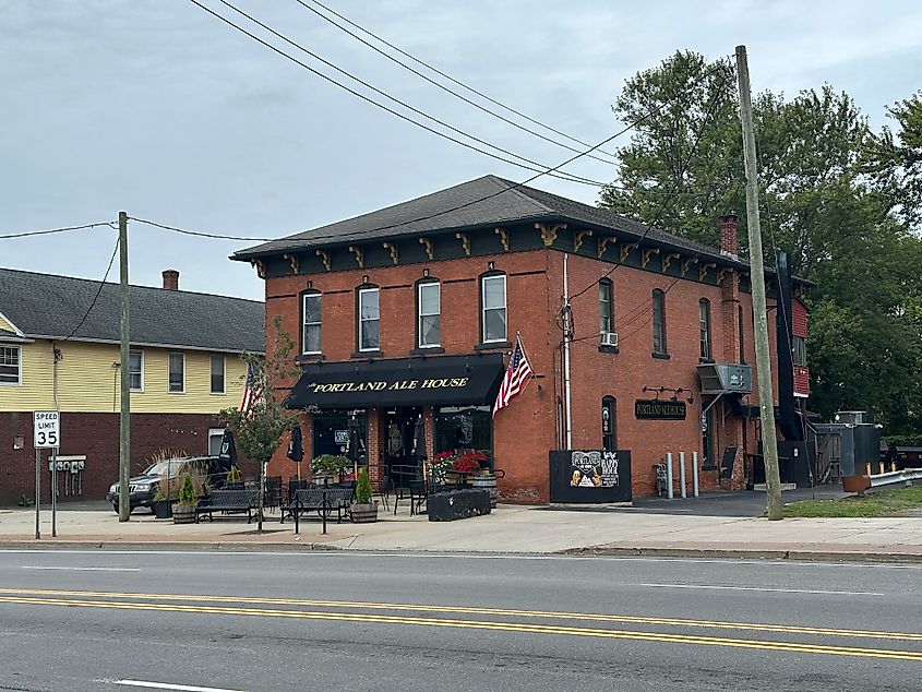 Exterior of red brick building in downtown area. Sign for Portland Ale House. 
