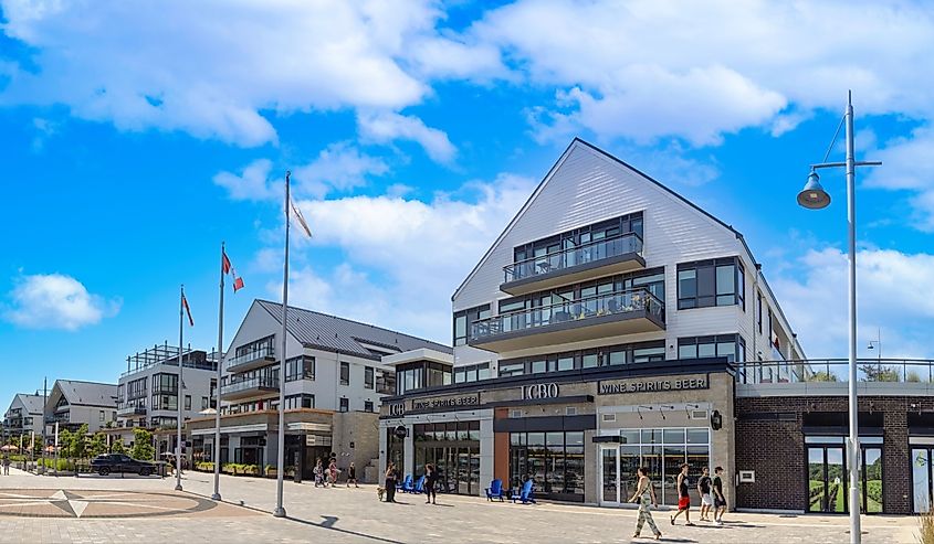 Scenic Innisfil town in Ontario and lake promenade with marina views, shops, cafes and restaurants