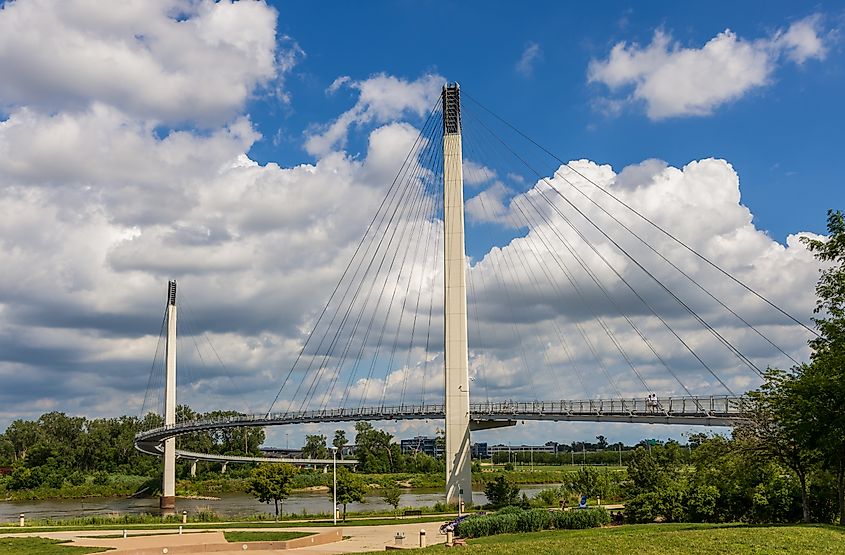 The Bob Kerrey Pedestrian Bridge spanning the Missouri River, connecting Omaha, Nebraska, with Council Bluffs, Iowa, with its signature curved design and cable supports