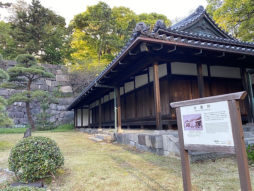 An old fashioned wooden Japanese barracks in front of a stone wall at Tokyo's Imperial Palace