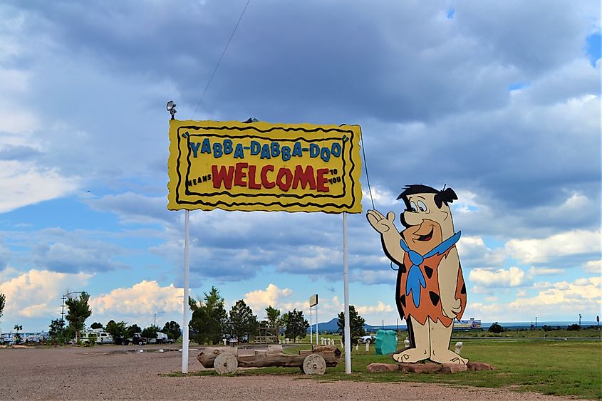Editorial Photo Credit: nick clephane via Shutterstock. valle,Arizona,USA,8 30 2013,Fred Flintstones on roadside sign