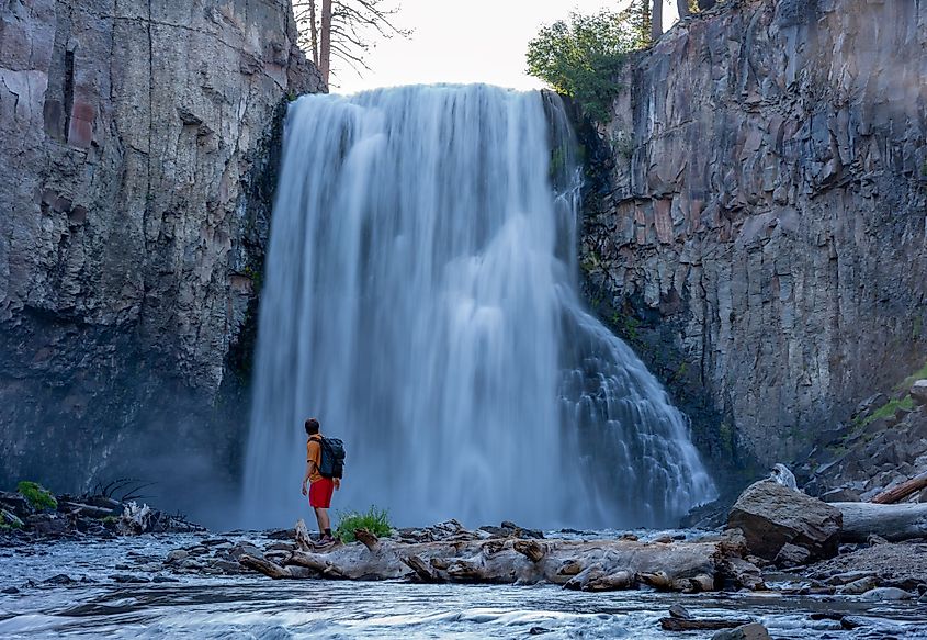 A hiker in front of the Rainbow Falls, California