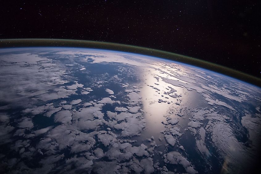 A view of Earth's atmospheric layers from orbit at the edge of sunlight.
