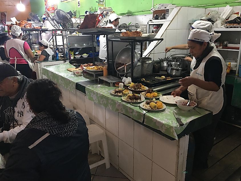Local Ecuadorian chefs serving up hot food in a large market