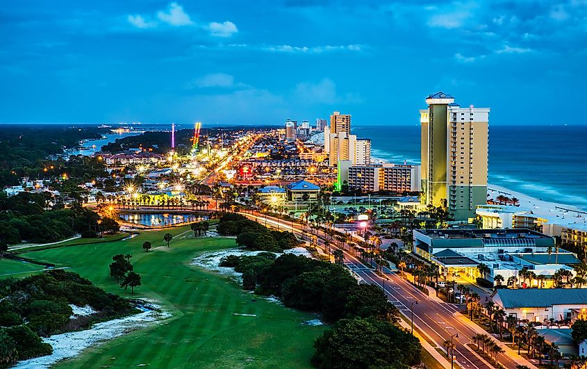 View of Front Beach Road in Panama City Beach, Florida, during blue hour at night.