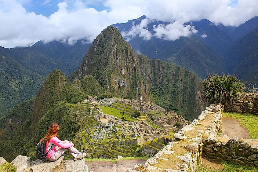 A woman enjoying the view of Machu Pichu in Peru