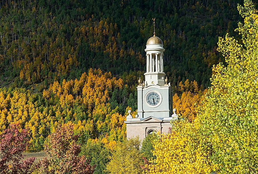 San Juan County Courthouse clock above the fall foliage in Silverton, Colorado.