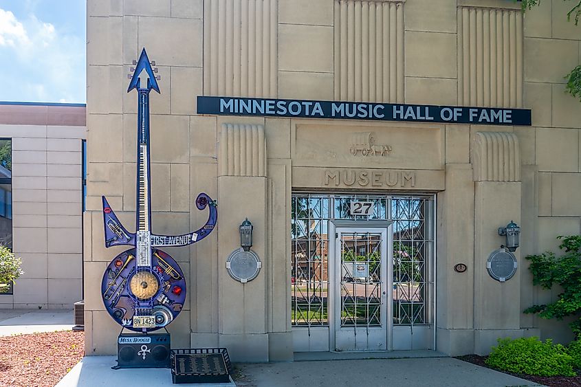 Editorial Photo Credit: EWY Media via Shutterstock. New Ulm, Minnesota -Jul 19, 2024: Minnesota Music Hall of Fame with sculpture of Princes guitar by Jefferson Davis. Museum exhibits honor Minnesota music legends.