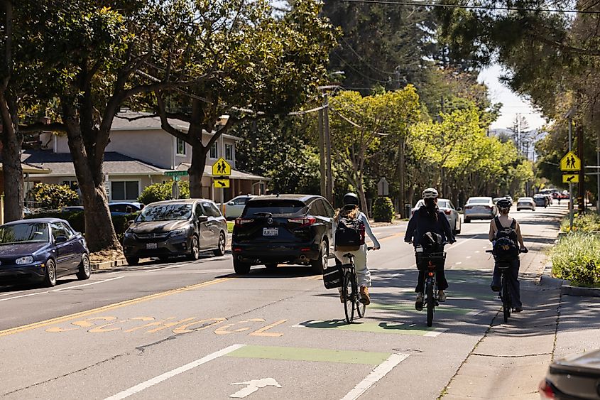 afternoon bicycle and vehicular traffic passes down Oak Grove Ave in Atherton, California.