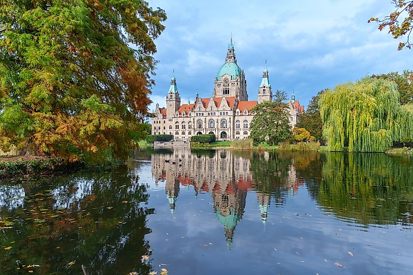 New City Hall of Hannover reflecting in water in the autumn, Hanover Maschpark, Lower Saxony, Germany. Via Shutterstock / Miroslav Srb.