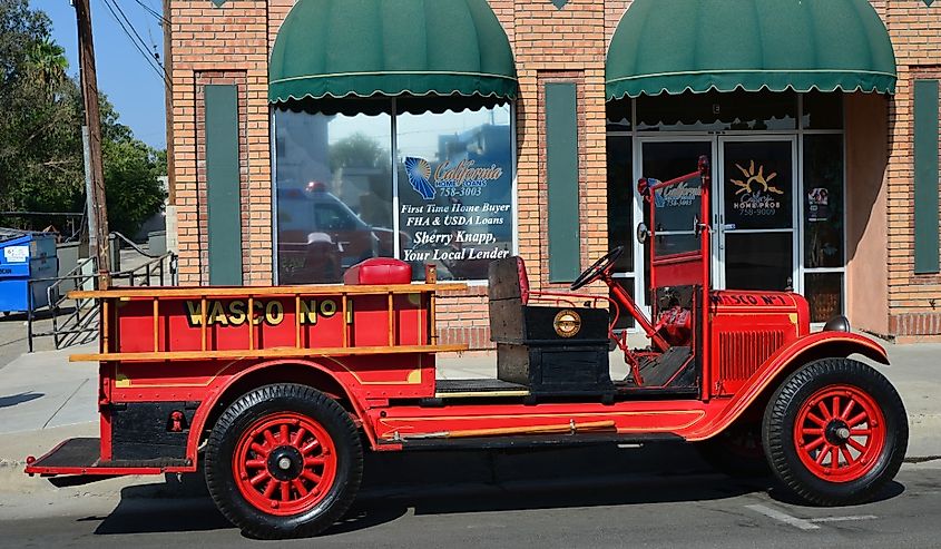 An antique fire engine idles at the curb in Wasco, California.