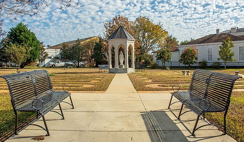 Prayer Garden of the St. Mary Basilica (Our Lady of Sorrows Cathedral) with the statue of Virgin Mary at the center in Natchez, Mississippi