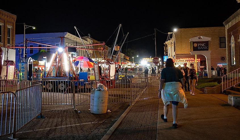 Carnival rides illuminate the streets of downtown Jackson on the last night of the Apple Festival