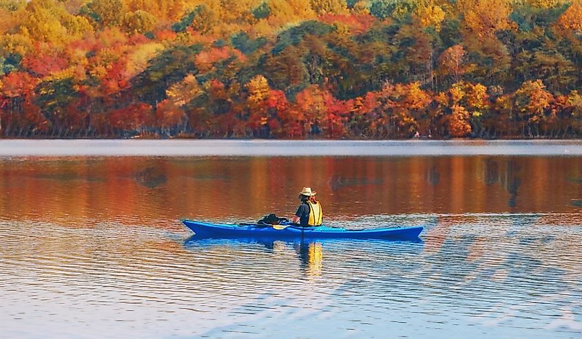 Kayaking Burke Lake in Virginia, with fall foliage.