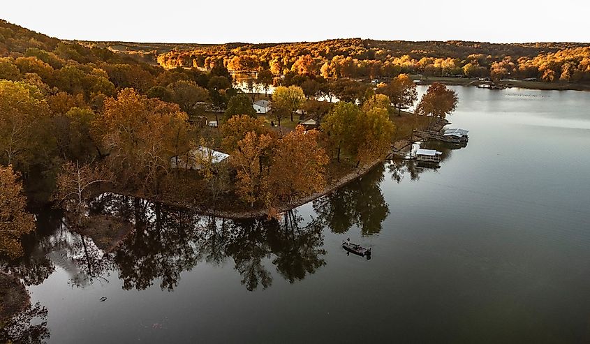 Fisherman fishing during fall sunrise on Grand Lake in Oklahoma