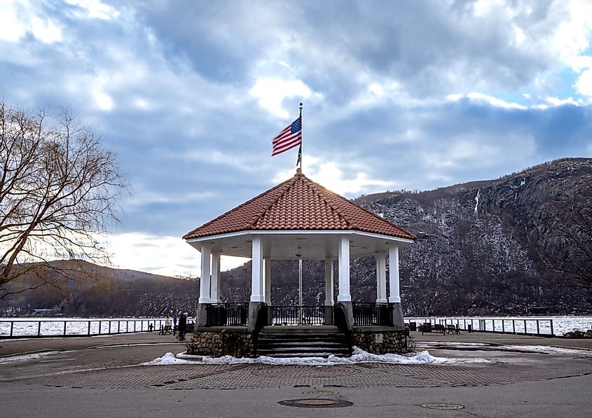 Horizontal sunset view of Cold Spring Pier Gazebo overlooking the frozen Hudson River in Cold Spring, New York