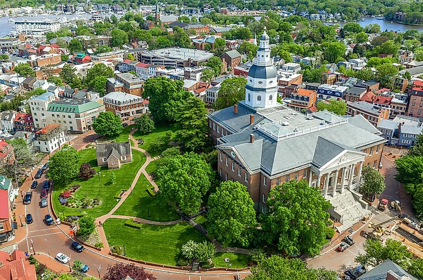 Aerial view of Maryland State House capitol building white dome and state circle with colonial houses.