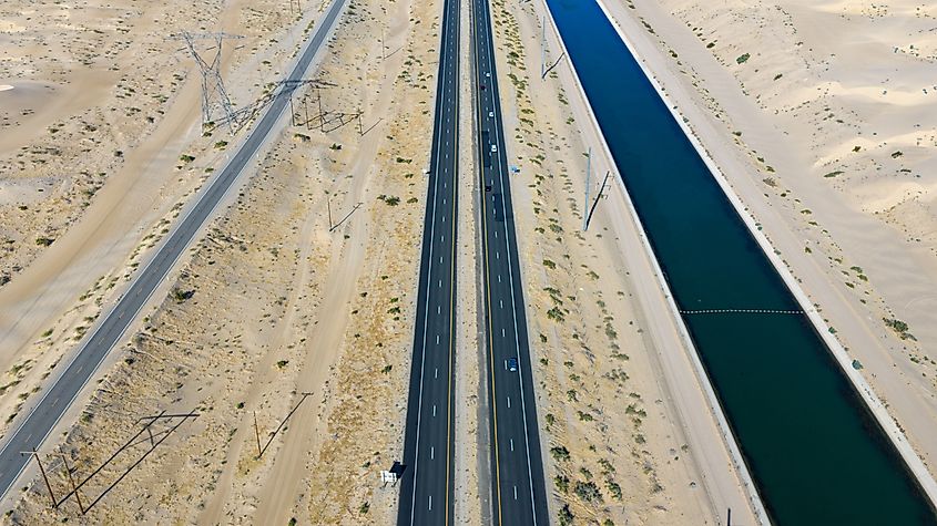 Aerial View of Desert Highway Running Parallel to All-American Canal with Power Line Towers in Algodones Desert, Imperial County California