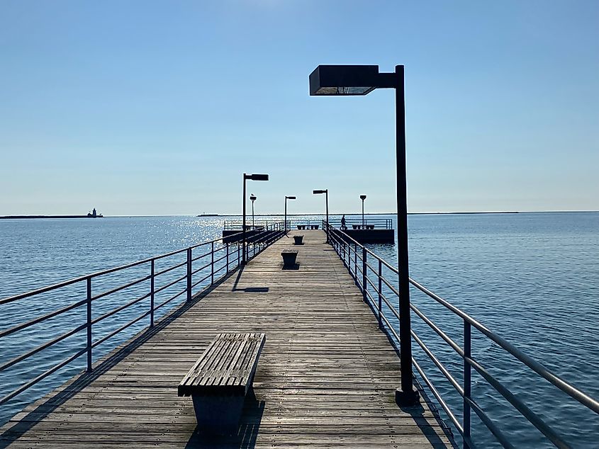 A POV of a morning walk out on a wooden lake pier.
