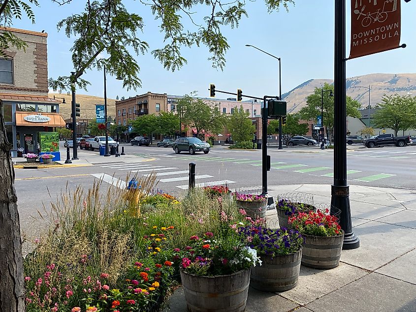 Flower pots and frontier business fronts at an intersection in downtown Missoula, MT.