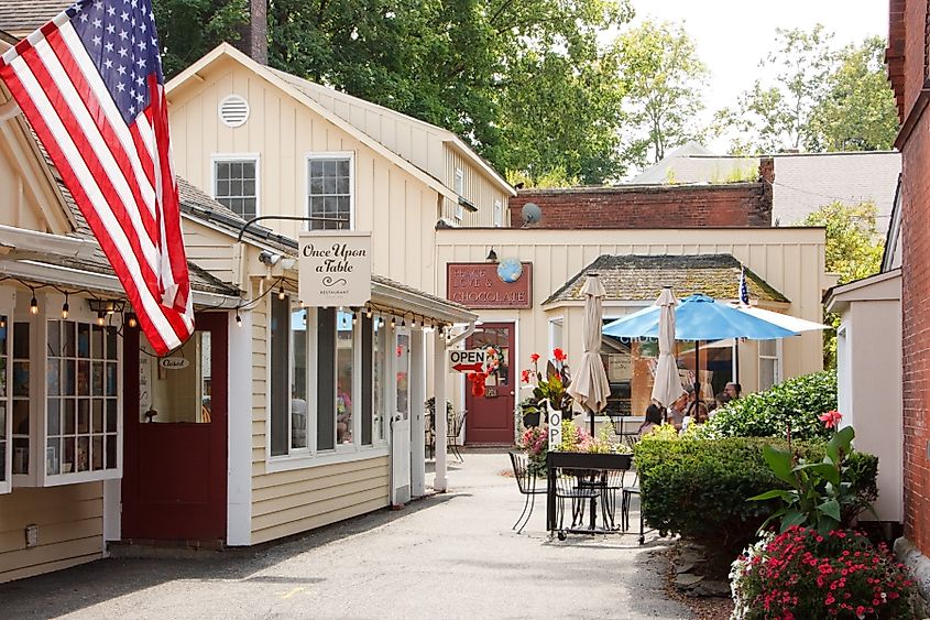 Stockbridge, Massachusetts, USA - August 5 2023: A pedestrian street lined with a traditional restaurant and a chocolate shop on a summer day.