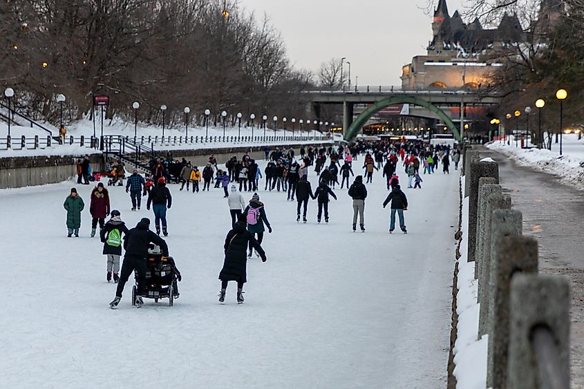 People skating on Rideau Canal in winter in downtown Ottawa, Canada.