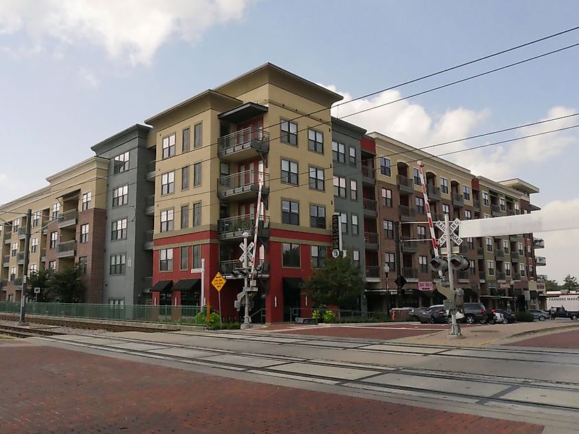 Modern buildings and apartments near a railroad crossing in downtown Plano, Texas