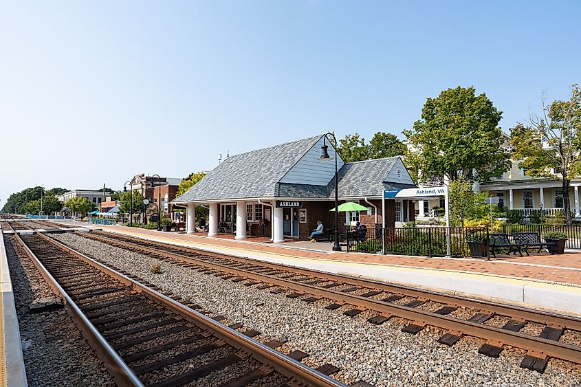 Ashland, Virginia train station with brick platform, tracks, and small depot building.