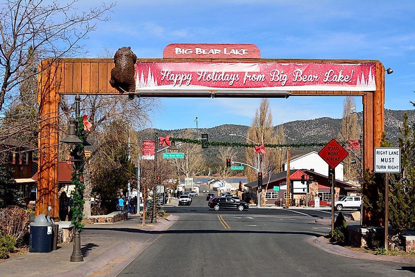 View of the main street, Pine Knot Avenue, in Big Bear Lake, with season decorations, buildings, and cars.