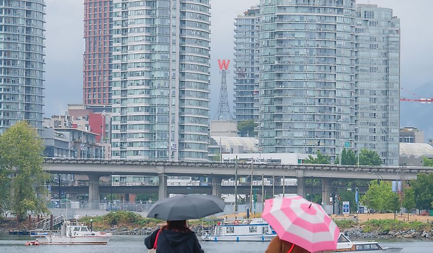 Rainy weather in Vancouver - people with umbrellas and some buildings.