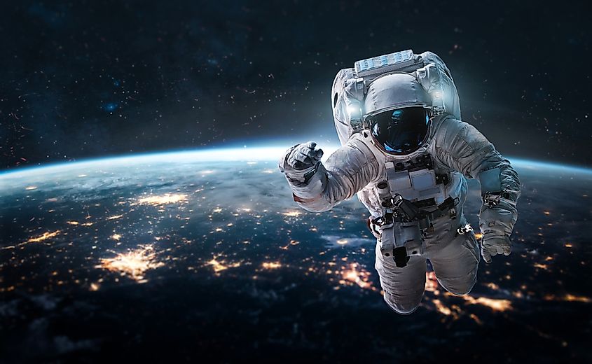 Astronaut in outer space over of the nightly Earth.