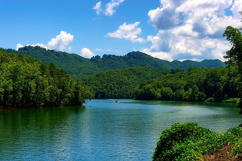 A view of the Nantahala River with two boats as seen from a moving train travelling through the Nantahala National Forest.