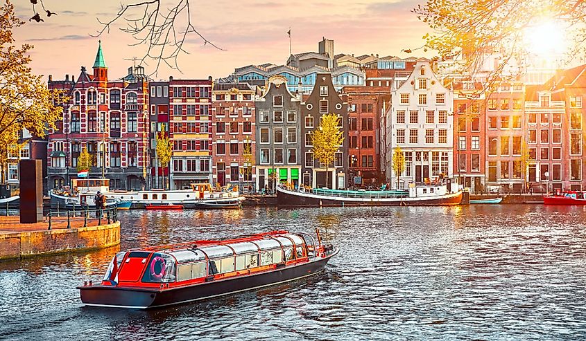 Channel in Amsterdam Netherlands houses river Amstel landmark old european city spring landscape