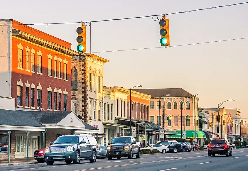 Cars driving down Broad Street at sunset in downtown Selma, Alabama.