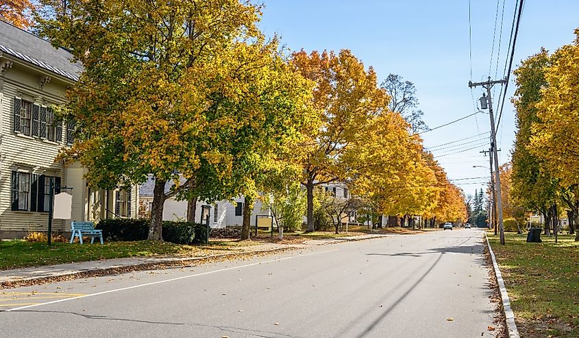 Homes along a street in fall, in Bethel, Maine.