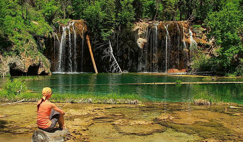 Woman admiring Hanging Lake, Glenwood Canyon, Colorado