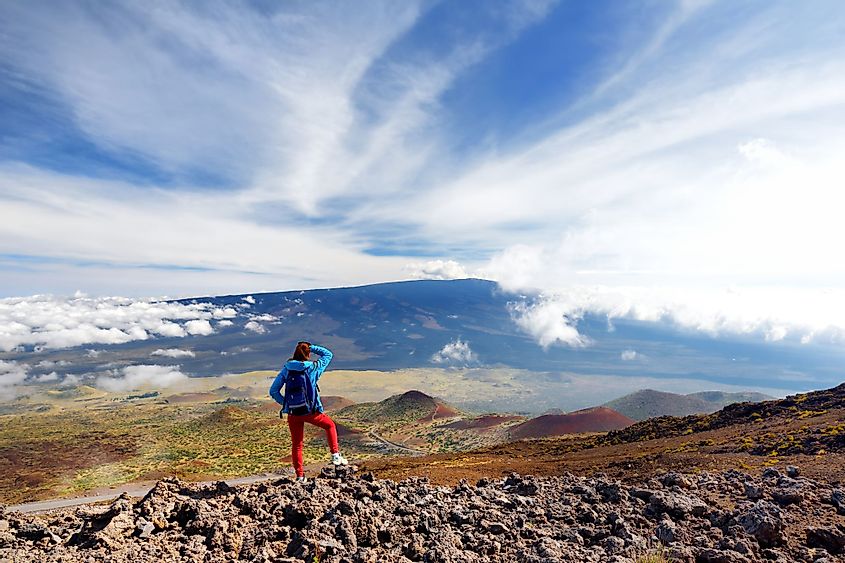 Tourist admiring the breathtaking view of Mauna Loa volcano on the Big Island of Hawaii.