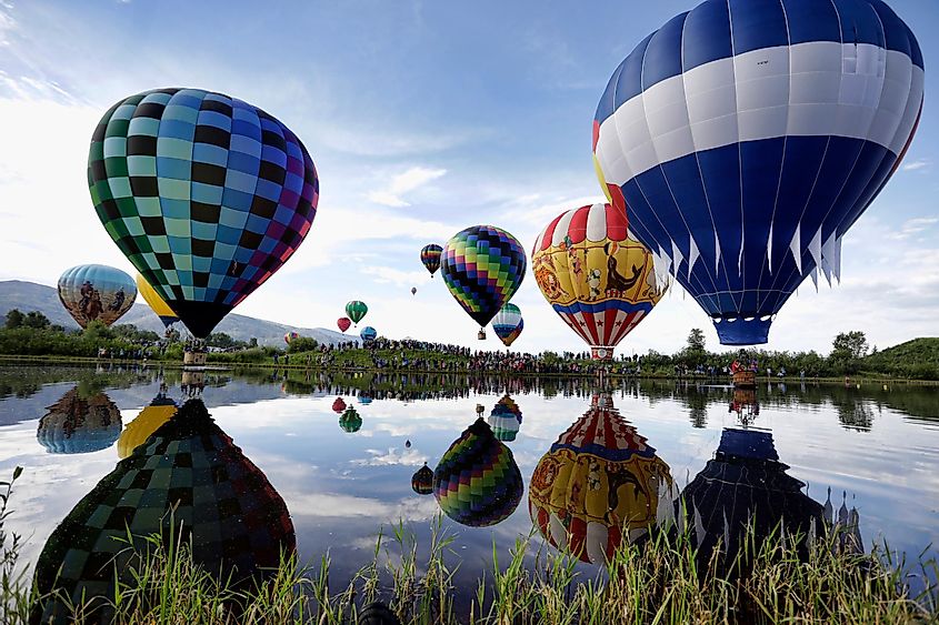 Balloons float over Bald Eagle Lake during the 38th annual Steamboat Springs Hot Air Balloon Festival in Steamboat Springs, Colorado on July 14, 2019