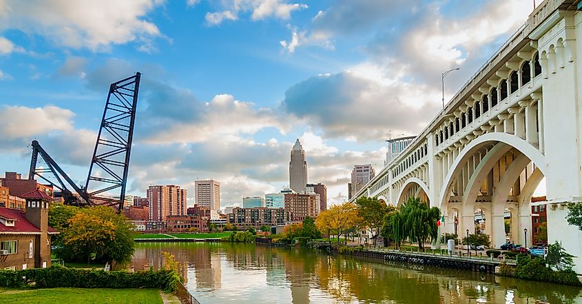 Editorial Photo Credit: Kenneth Sponsler via Shutterstock. The Cuyahoga River bends past downtown Cleveland by the Veterans Memorial Bridge with old lift bridge at left