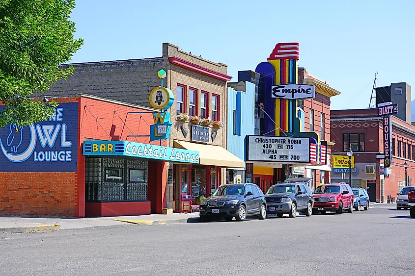 A view down Main Street in downtown Livingston, Montana, with low-rise historic buildings and the Absaroka Range behind.